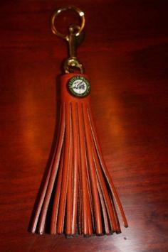 Handmade by Amish artisans in Ohio, the leather tassel key rings at Virginia's Inn at Little Washington are also adorned with a glass logo rosette akin to those used on dressage show halters.