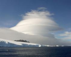 Lenticular clouds, Antarctica. They form because of vagaries of winds around mountain peaks.     Credit: lfstewart  (Lenticular clouds, like the ones seen in Antarctica (shown here), are so smooth and round that they're sometimes mistaken for UFOs. Like some other cloud formations, including wave clouds, lenticular clouds form because of the vagaries of winds around mountain peaks).