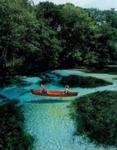 Slovenia. The water is so clear it looks like their boat is floating on air