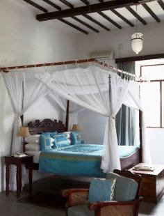 The blue colors add a gorgeous splash of color to the simple decor of this hotel room in #Mozambique.