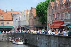 Tourists lining Bruges Canal