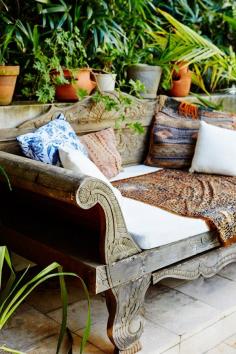 Teak daybed with a mx of pillows.