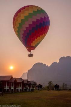 
                        
                            Vang Vieng, Laos, Vang Vieng, Laos - A hot air balloon defends close to the bungalows on sunset in Vang Vieng #Troveon  jimmyeatsworld.com
                        
                    