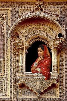 
                        
                            Indian lady looking out of a Jharokha (ornate window)
                        
                    