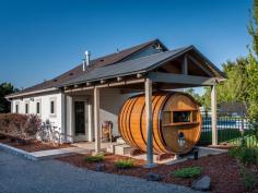 
                        
                            This two-bedroom home boasts an airy, open concept layout, but it also includes an additional sleeping area on the patio: a wine barrel that once housed more than 1,000 gallons of wine.
                        
                    