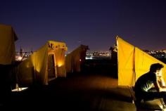 
                        
                            Check out this pop-up campground and art project that has begun pitching its artist-constructed tents on secret city rooftops for a night of outdoor fun.
                        
                    