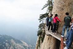 
                    
                        Mount Huashan, China consists of five peaks. The trails up Mount Huashan involve steep staircases, vertical ascents, and a plank trail consisting of wooden platforms bolted onto the mountainside.  WAIT-who built these??
                    
                