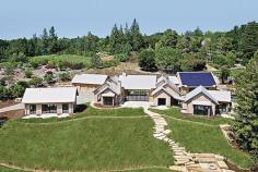 
                    
                        This net-zero LEED Platinum house extends its earth-friendly ethic to the landscape. A pilot project of the Sustainable Sites Initiative, the 2.7-acre site was designed to respond to natural land forms, vegetation, hydrology, and wildlife patterns, and a specially developed sod grass is targeting 80 percent water reduction.
                    
                