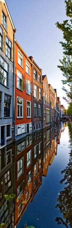 
                    
                        Reflections of homes in a canal of Delft, Netherlands
                    
                