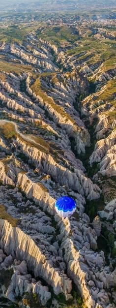 
                    
                        Balloon flying over eroded landscape, Cappadocia, Turkey
                    
                
