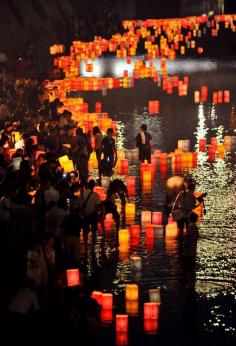 
                    
                        Paper lanterns floating on the Motoyasu River at the Peace Memorial Park in Hiroshima, Japan.
                    
                