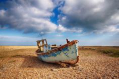 
                    
                        A fishing boat sitting on the beach near the lifeboat station. A stunning place to visit. Discovered by Snappy David at Dungeness Lifeboat Station, Kent, England
                    
                