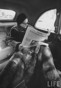 
                    
                        Newsday publisher Alicia Patterson reading her newspaper in backseat of her chauffeur-driven limousine, with large fur lap robe covering her legs, en route to LI office from NYC. Long Island, NY (1958). LIFE.  Great-granddaughter of Joseph Medill, owner of the Chicago Tribune, Patterson found her calling late in life when her third husband, Harry Guggenheim, used $750,000 of the Guggenheim family’s fortune to help found the Nassau Daily Journal, also known as Newsday. books0977.
                    
                