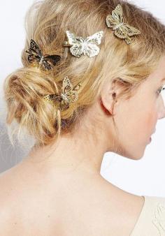 
                    
                        Close-up view of messy hair bun with butterfly hair clips.
                    
                