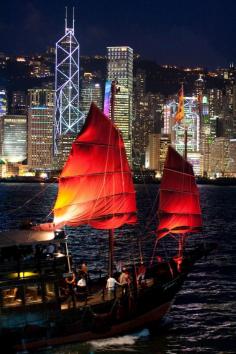 
                    
                        A traditional Chinese "junk" plys the waters of  Victoria Harbour in Hong Kong
                    
                