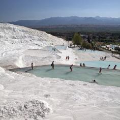 
                    
                        Pamukkale, Turkey | Pamukkale, or “Cotton Castle,” is a natural site in southwestern Turkey that is home to hot springs and travertines, terraces of carbonate minerals left by the flowing water. People can relax in the small turquoise pools of bliss, but the terraces themselves are restricted to preserve the site.
                    
                