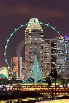 
                    
                        Singapore flyer with skyscrapers on background at night, view from Marina Barrage
                    
                