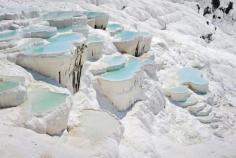 
                    
                        Pamukkale, Turkey. Photo by Serghei Starus/Shutterstock. Pamukkale, or “Cotton Castle,” is a natural site in southwestern Turkey that is home to hot springs and travertines, terraces of carbonate minerals left by the flowing water. People can relax in the small turquoise pools of bliss, but the terraces themselves are restricted to preserve the site.
                    
                