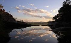 
                    
                        The evening sky reflects on to the infinity pool at Gunlom falls, one of Kakadu’s star attractions.
                    
                