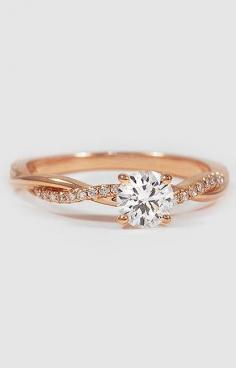
                    
                        This beautiful ring features a strand of diamonds entwined with a high polished ribbon of rose gold.
                    
                