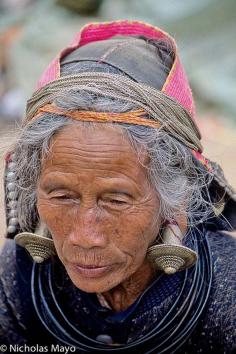 
                        
                            Western China | Wa woman wearing traditional earrings.  Yunnan | ©Nick Mayo
                        
                    