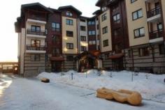This apartment hotel is located in the foothills of the Pirin Mountain in the Bansko ski resort, just metres from the ski lift station. The centre of Bansko is 300 m away, where guests will find a range of shops, restaurants and nightlife venues. The bus and railway station is located approximately 800 m from the accommodation and Plovdiv Airport and Sofia Airport lie 146km and 160km away, respectively. Situated in an excellent location, this hotel comprises 60 apartments in total, and is spread over 4 floors. Its exterior and interior design add to the wintertime's fairytale ambience and make it one of the most attractive hotels in Bansko. Guests are welcomed into a lobby with a 24-hour reception and check-out service and safe, and there is a café and bar on site. WLAN Internet access is provided throughout public areas and younger guests will enjoy the children's playground. Garage parking is available for those arriving by vehicle. The nicely furnished apartments come with either one or two bedrooms, a living room, a balcony or terrace, a fully equipped kitchenette (with a refrigerator, microwave and tea and coffee making facilities), a dining area and a bathroom fitted with a shower and bathtub. They feature either 1 queen or 2 single beds (which can be made into 1) as well as a sofa-bed and armchairs. Further amenities include satellite TV, Internet access and individually regulated heating units. The modern spa centre features an indoor swimming pool, sauna, hot tub and steam room, and relaxing massage treatments can also be booked (fees apply to all of the above). Active types can stay fit in the on-site gym (fees apply).A bed and breakfast package is available upon request, payable on site. The distance from Sofia to Bansko is approximately 160km. Upon entering Bansko, continue onto the main street Glazne Street, then drive through all 3 traffic lights and after 50 m, the hotel sign will be visible on the left-hand side.
