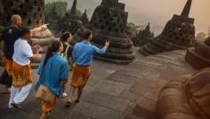 Travellers walking through Yogyakarta Borobodur Temple in Java, Indonesia